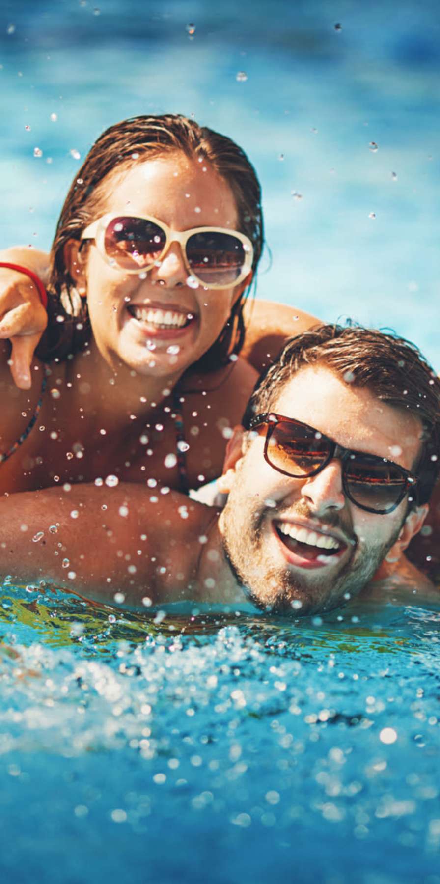 Friends posing for a photo in the pool at Brookside Downtown in Columbia, Missouri