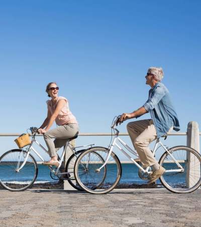 Residents exploring nearby area on a bicycle at Athens Vista Senior Apartments in Los Angeles, California