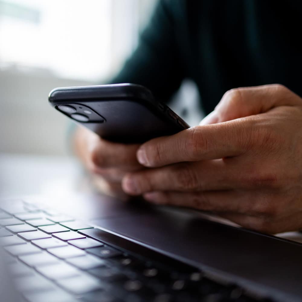 Resident using his mobile phone at Broadway Villas in Los Angeles, California