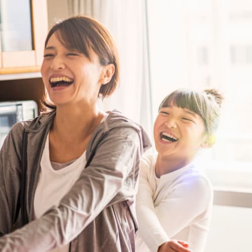 A mother and daughter laughing in their home at Heroes Manor in Camp Lejeune, North Carolina