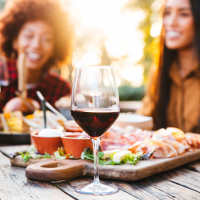 Residents enjoying food at a restaurant near Woodchase Apartments in San Leandro, California