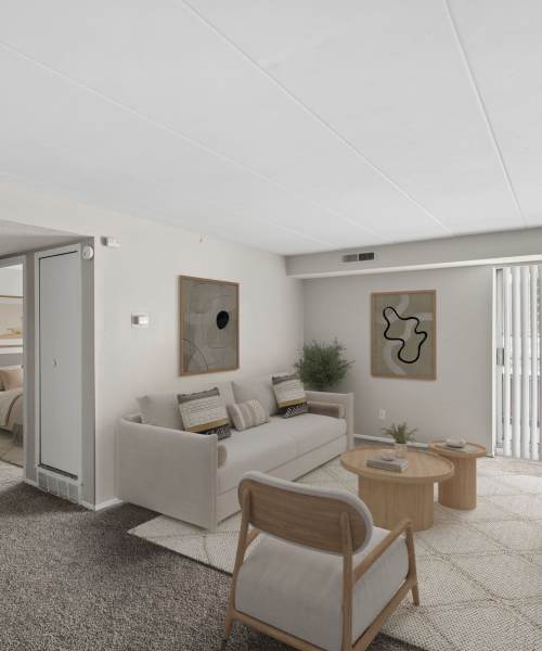 Stylish living room with cozy seating, indoor plants, and natural decor at Granada Gardens Apartments in Warrensville Heights, Ohio