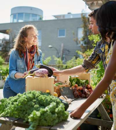 Resident buying fresh produce at a grocery store near Granada Gardens Apartments in Warrensville Heights, Ohio