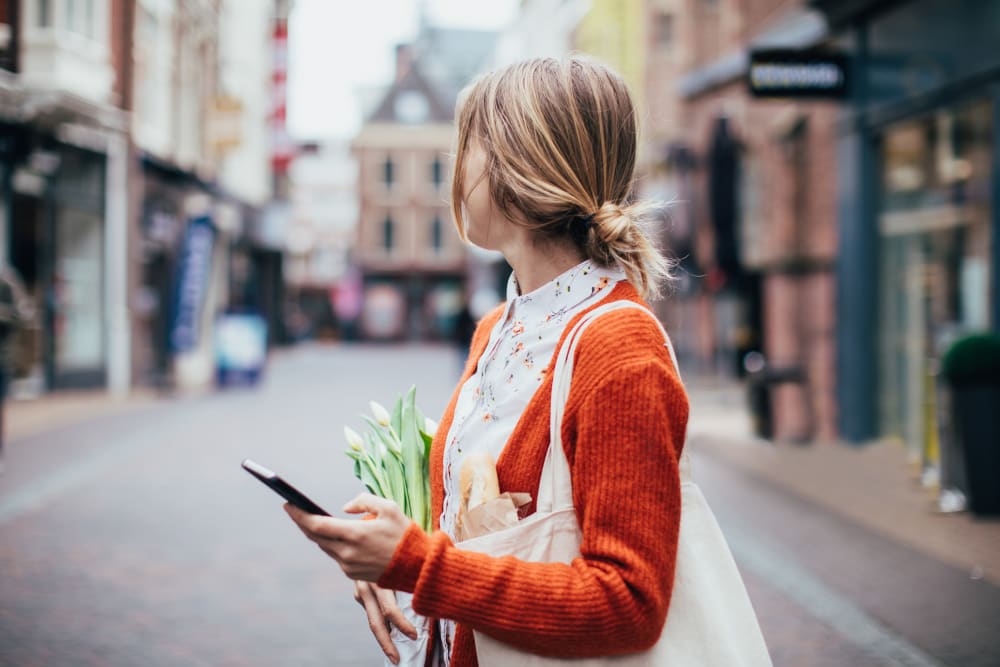 Women running errands around her neighborhood near The Sutton Collection in New York, New York