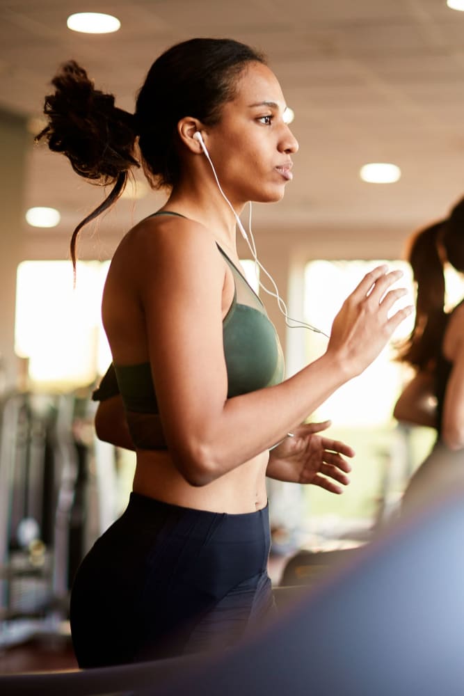 Running on the treadmill in the fitness center at 55 Brighton at Packard Crossing in Boston, Massachusetts