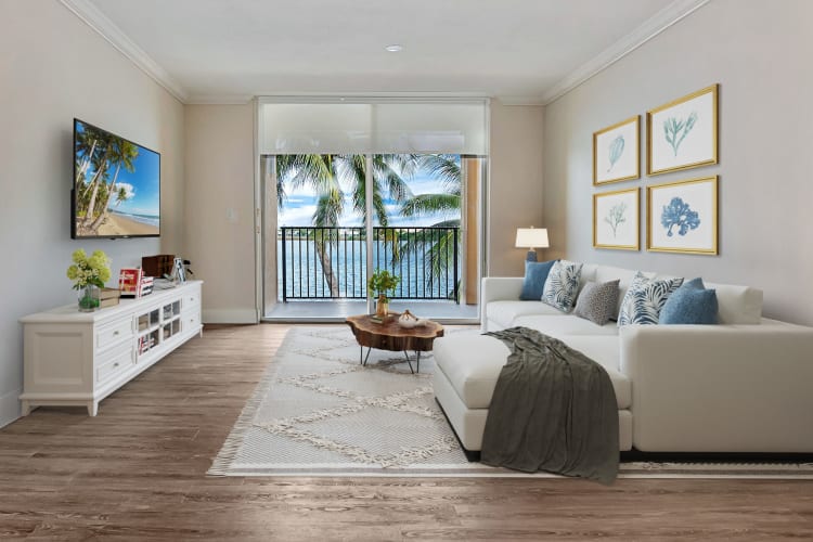 Beautiful model living room with lake views at St. Tropez Apartments in Miami Lakes, Florida