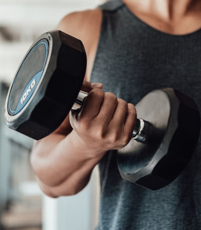 Resident lifting weights at Coffee Creek Apartments in Owasso, Oklahoma