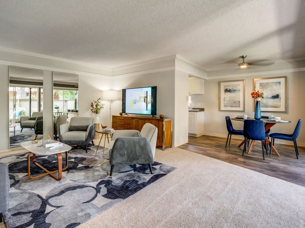 Spacious and modern open-concept floor plan with plush carpeting in a model home at Sofi Fremont in Fremont, California