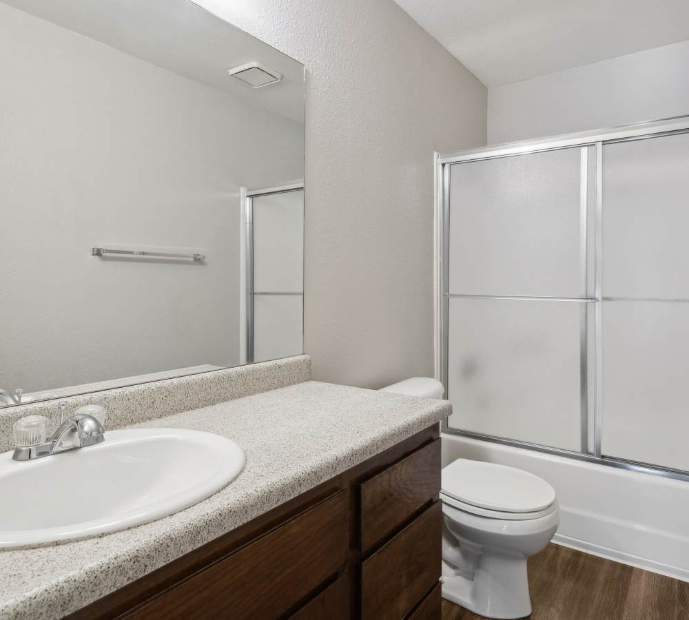 Bathroom with brown cabinets at Muirwood Apartment Homes in Martinez, California