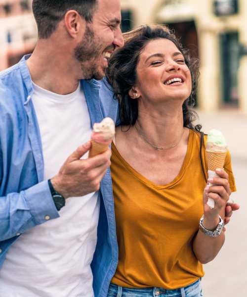 A happy couple eating ice cream near Brentwood Apartments in Portland, Oregon