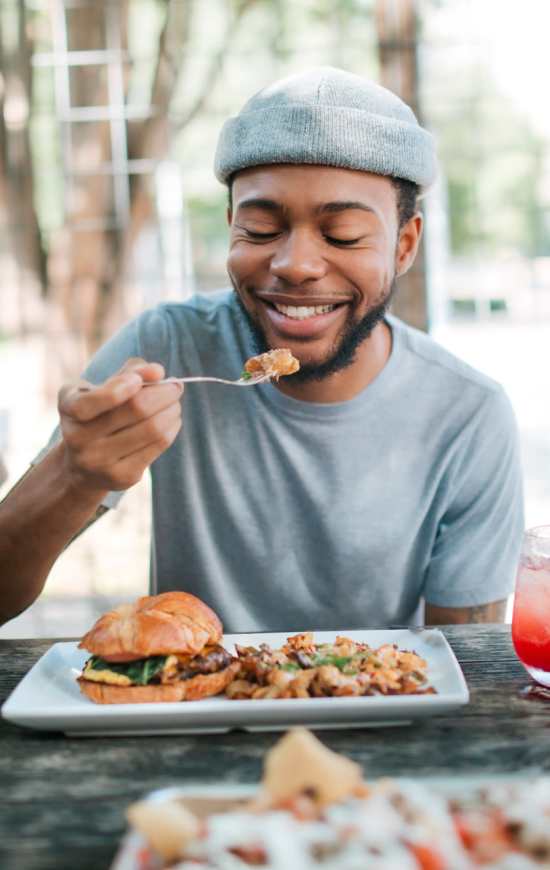 Student eating food at Brookside Downtown in Columbia, Missouri