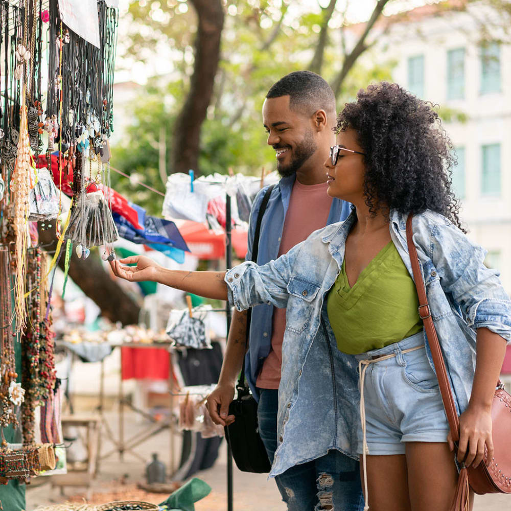 Resident couple shopping at an outdoor market near our Rafael Gardens community at Mission Rock at Novato in Novato, California