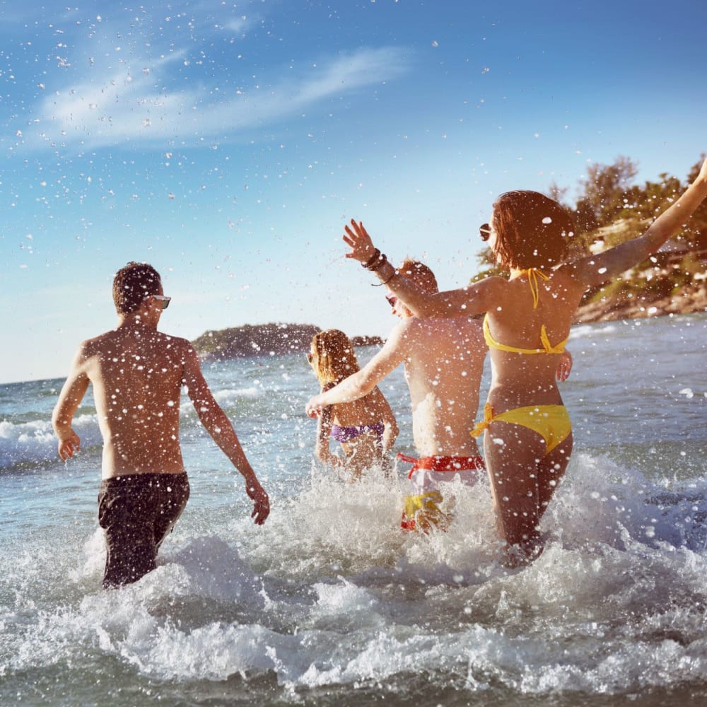 Family swimming on beach near  Beachside Apartments in Satellite Beach, Florida