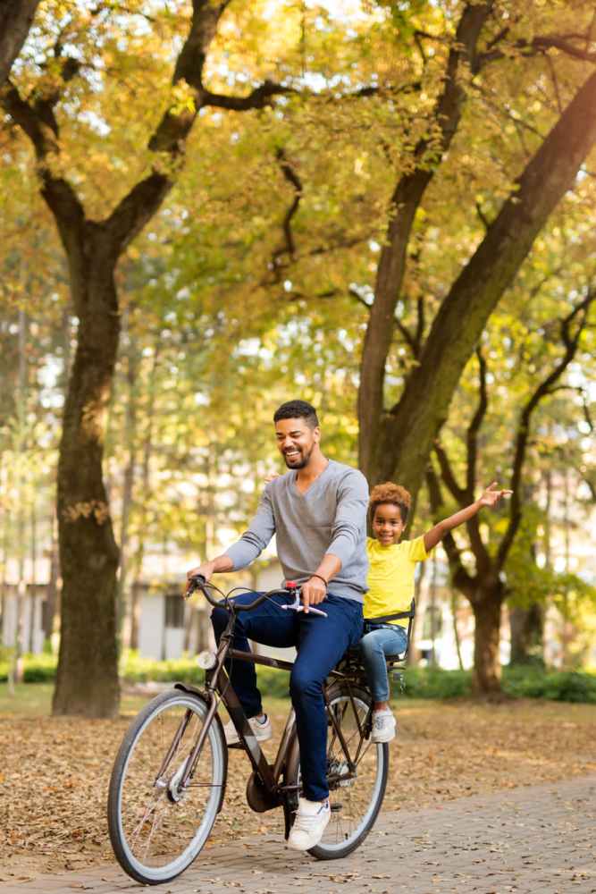 Smiling resident and his son going on a ride near Textile Lofts in Cleveland, Ohio