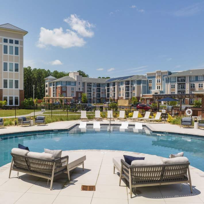 Pool with lounge chairs at Attain at Harbour View, Suffolk, Virginia