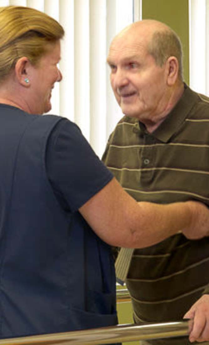 Staff helping client with his daily rehabilitation at O'Fallon in O'Fallon, MO