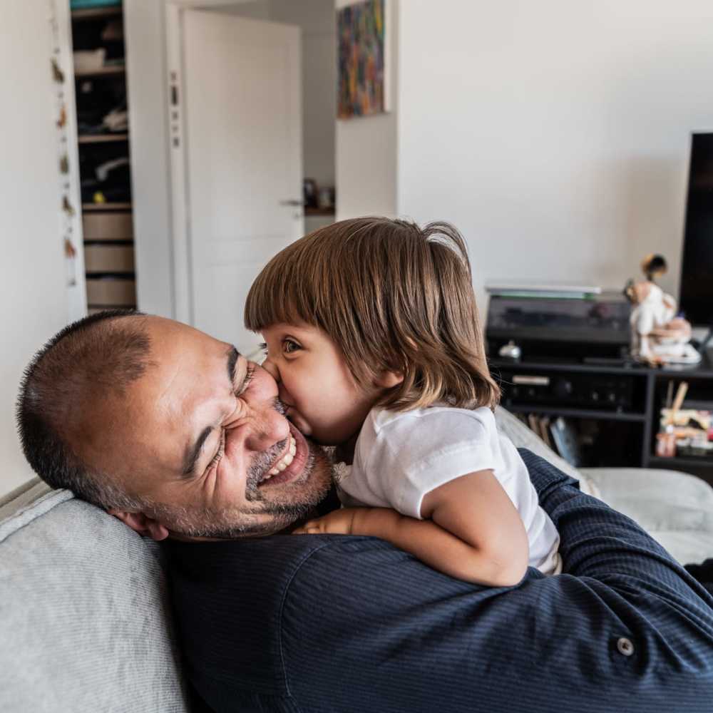 Resident playing with his daughter at Tucasa Townhomes in Irving, Texas