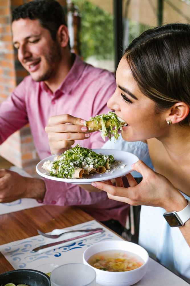 Resident couple having food near El Patio Apartments in Laredo, Texas