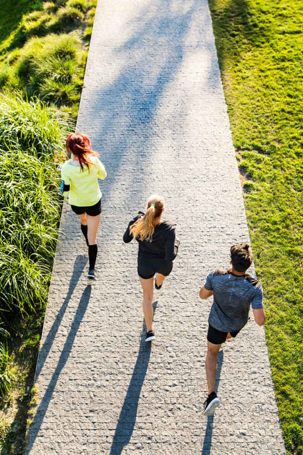 Residents jogging in a park nearby The Abbey at Spring Town Center in Spring, Texas