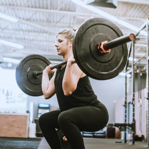 A woman lifting weights at San Onofre I in San Clemente, California