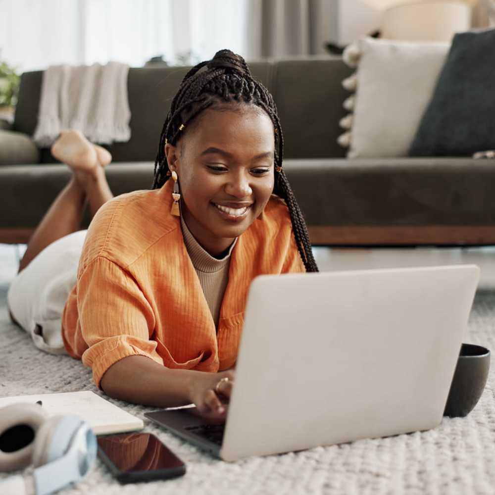 Resident using laptop at Lakewood Manor Apartments in Rochester, New York
