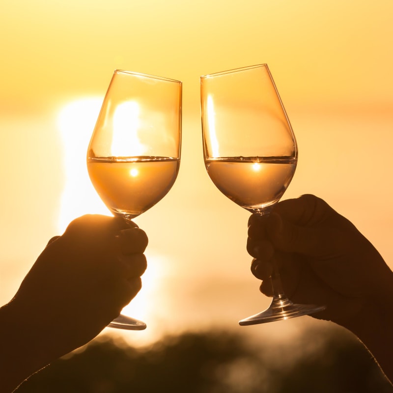 Couple toasting the good life at sunset at Portside Ventura Harbor in Ventura, California