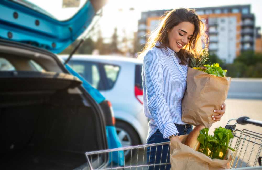 Resident with her grocery shopping bags near Reidy Creek Apartments in Escondido, California