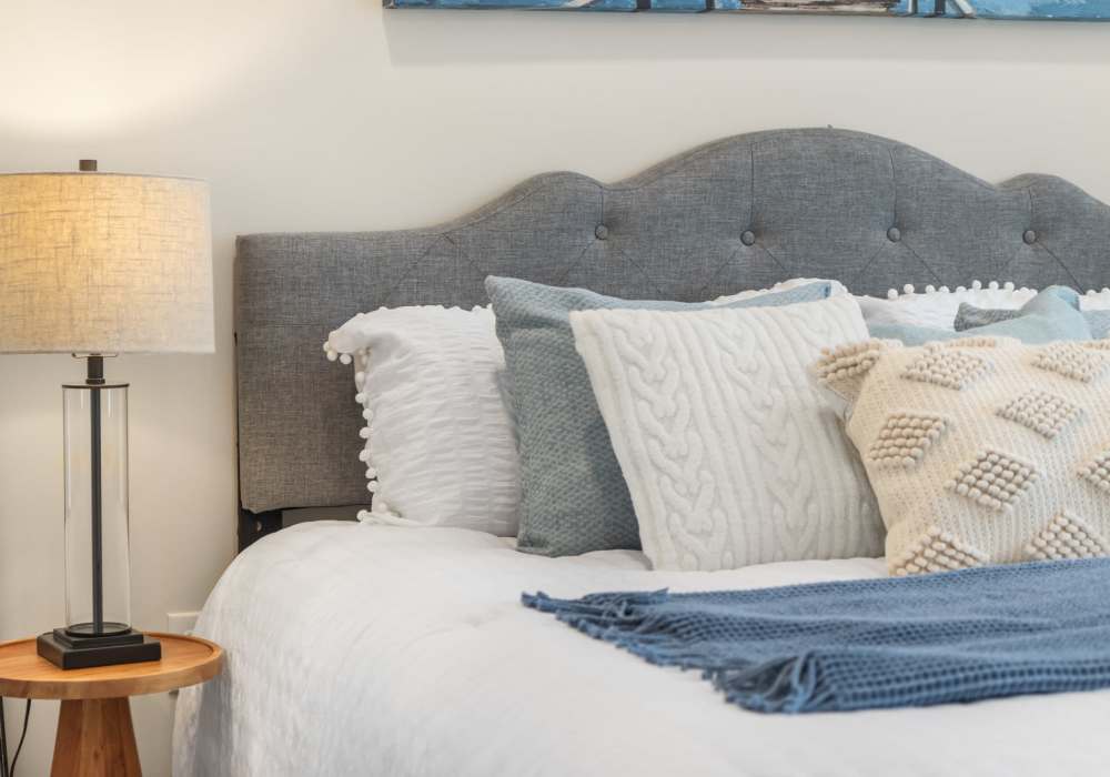 Bedroom with a large comfortable bed at Heritage Park Apartments & Townhomes in Webster, New York