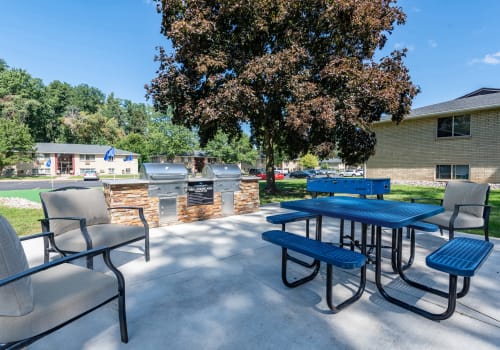 Grilling area with picnic seating of Long Pond Gardens Senior Apartments in Rochester, New York