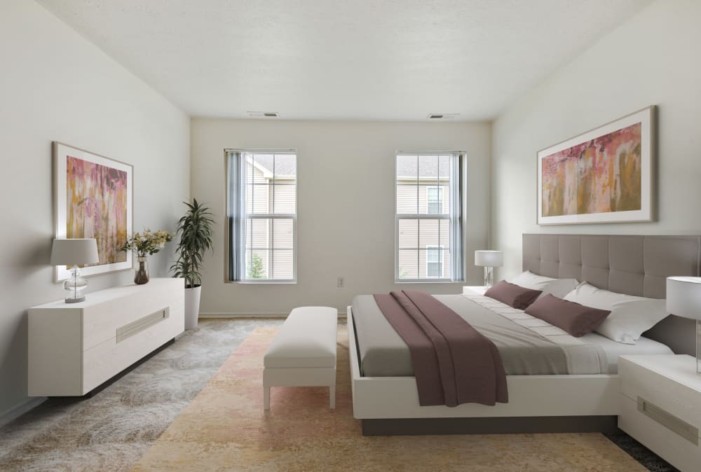Bedroom with bed and brown carpet at Avon Commons Apartments