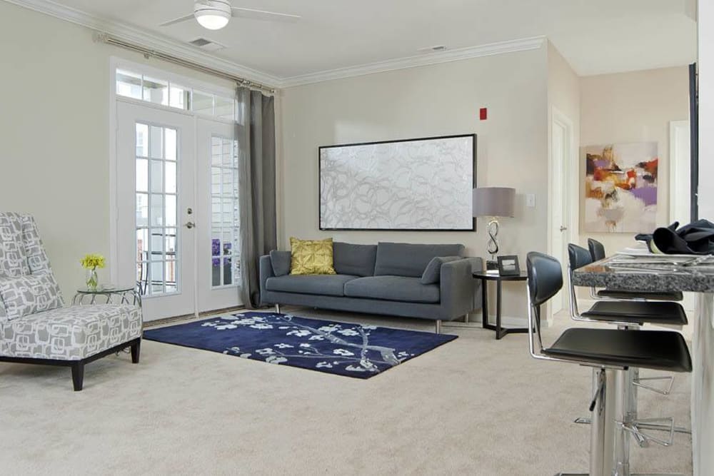 Open concept well lit living room with carpet at The Morgan in Chesapeake, Virginia