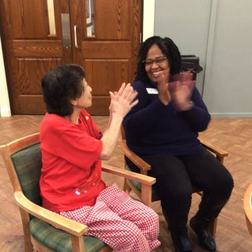 Resident coloring with caretaker at Oxford Glen Memory Care at Carrollton in Carrollton, Texas