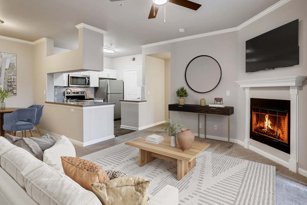 Living room with a ceiling fan and fireplace at Alize at Aliso Viejo Apartment Homes in Aliso Viejo, California