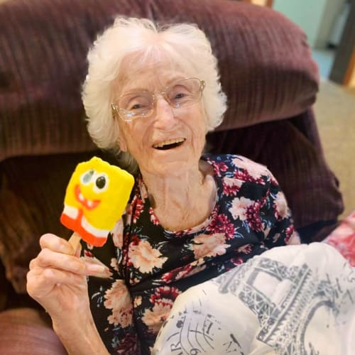 A resident eating an ice cream at Oxford Glen Memory Care at Owasso in Owasso, Oklahoma