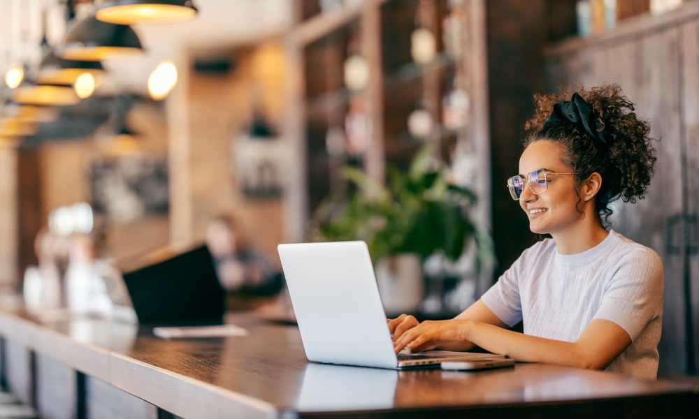 Resident using laptop at Williston Pointe in Gainesville, Florida