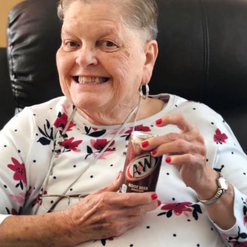 Resident holding a soda at Oxford Glen Memory Care at Sachse in Sachse, Texas