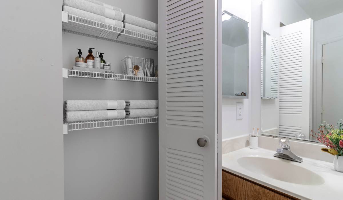 Bathroom cabinet with towels and toiletries at Tamarack on the Lake in Fayetteville, North Carolina