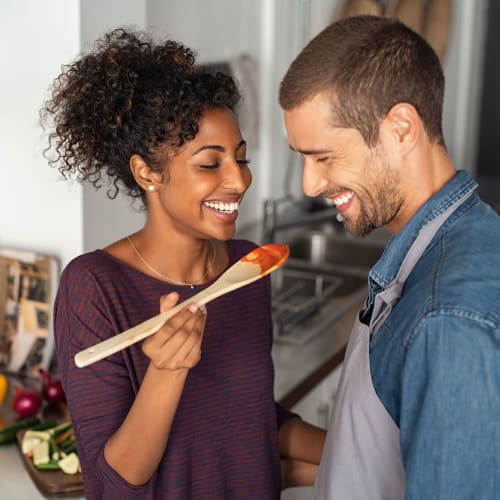 A smiling couple makes dinner at SoLa Apartments in Los Angeles, California