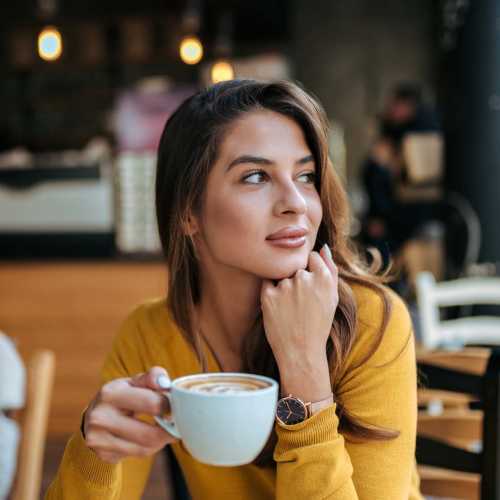 Woman having coffee near The Sycamores in Indianapolis, Indiana