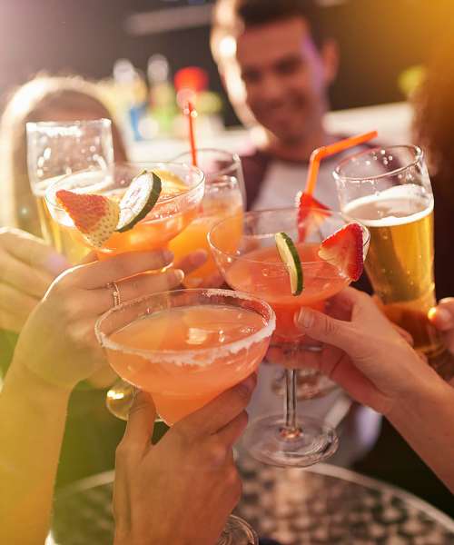 A group of friends toasting their glasses near The Crossroads At Downtown Boca in Boca Raton, Florida