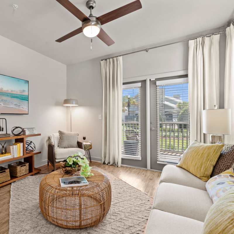 A living room with hardwood flooring and modern furnishings at Pier Park Crossings in Panama City Beach, Florida