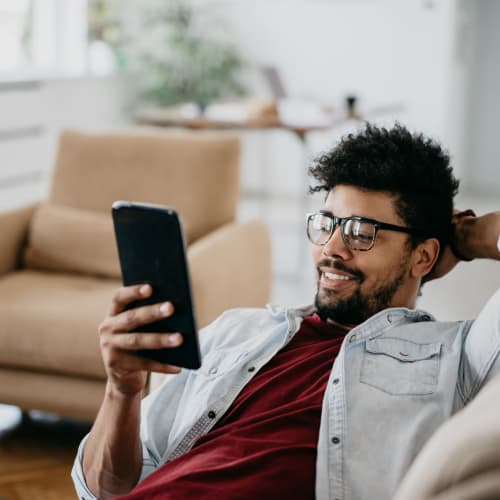 A resident using a cell phone in a home at Osprey Point in Virginia Beach, Virginia