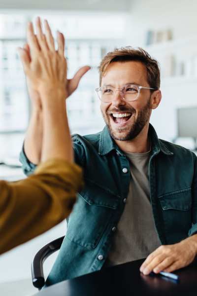 Employee high fiving at Wilhoit Properties, Inc. in Springfield, Missouri