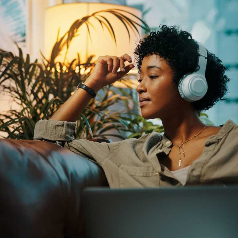 A resident listens to music with her headphones in her apartment at Commons on Potomac Square, Sterling, Virginia