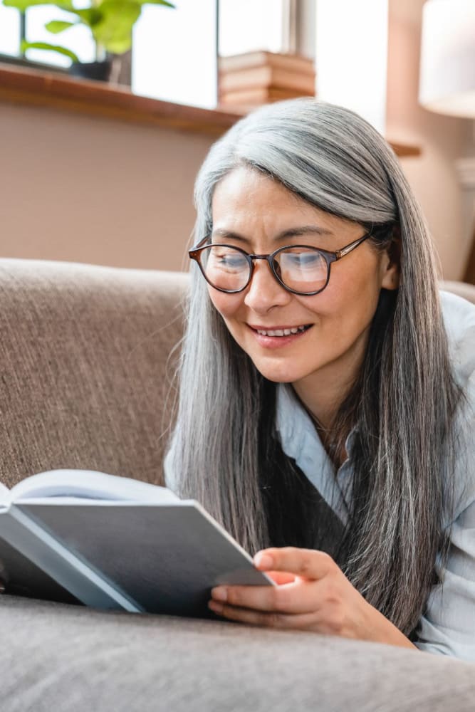 Resident reading in her home at Auburn Villas Senior Apartments in Auburn, California