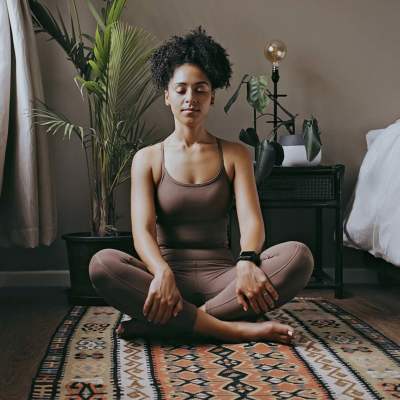 Woman doing yoga in her living room at Emerald Place in Lancaster, Ohio