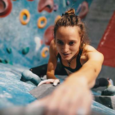 Resident climbing at an indoor rock gym near Linden Hill in Magna, Utah