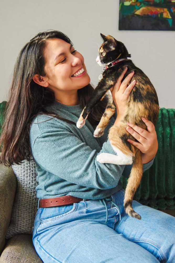 Resident woman and her cat in their new home at The Trail Lakes in Fort Worth, Texas