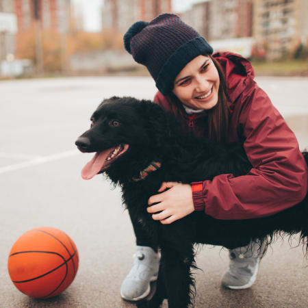 Happy pup and owner playing basketball near Anatole at the Pines in Conroe, Texas