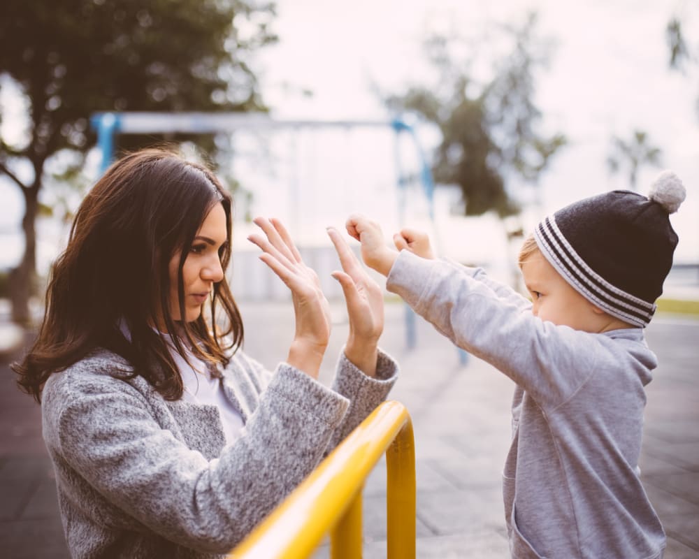 A mother and her son playing at a playground near Joshua Heights in Twentynine Palms, California